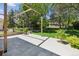 Stone patio with pergola, green landscaping, and a large grassy area with trees at 6393 S Jamaica Ct, Englewood, CO 80111