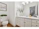 Bright bathroom with white cabinets, neutral walls, modern lighting, and wood-look floors at 6393 S Jamaica Ct, Englewood, CO 80111