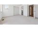 A bright bedroom featuring neutral carpet, white walls, window, closet, and access to the bathroom at 6393 S Jamaica Ct, Englewood, CO 80111