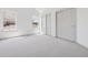 A light filled bedroom featuring neutral carpet, white walls, two windows and closet with sliding doors at 6393 S Jamaica Ct, Englewood, CO 80111