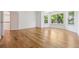 Bright bedroom with hardwood floors, white walls, natural light from multiple windows, and an open doorway at 6393 S Jamaica Ct, Englewood, CO 80111