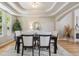 Formal dining room with a unique ceiling design, elegant furnishings, and natural light creating a sophisticated ambiance at 6393 S Jamaica Ct, Englewood, CO 80111