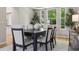 Formal dining room with seating for six, stylish decor and natural light from large windows overlooking the landscaped yard at 6393 S Jamaica Ct, Englewood, CO 80111