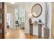 Welcoming foyer featuring hardwood floors, elegant console table, and a decorative mirror creating an inviting entrance at 6393 S Jamaica Ct, Englewood, CO 80111