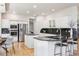 Bright kitchen with white cabinets, stainless steel appliances, granite countertops, and a cozy breakfast area at 6393 S Jamaica Ct, Englewood, CO 80111