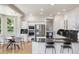 Modern kitchen with black granite countertops, stainless steel appliances, and an adjacent breakfast nook at 6393 S Jamaica Ct, Englewood, CO 80111