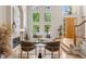 Bright living room with soaring ceilings, a fireplace, large windows, and wood floors is perfect for gathering and relaxing at 6393 S Jamaica Ct, Englewood, CO 80111