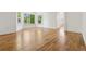Spacious living room boasts gleaming hardwood floors, bright white walls, and ample natural light through large windows at 6393 S Jamaica Ct, Englewood, CO 80111