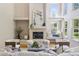 Bright living room featuring high ceilings, large windows, a fireplace, and stylish decor for a comfortable living space at 6393 S Jamaica Ct, Englewood, CO 80111