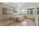 Elegant bathroom with a step-up tub, glass-enclosed shower, and a serene, spa-like atmosphere at 6393 S Jamaica Ct, Englewood, CO 80111