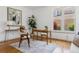Bright home office featuring a modern desk, stylish decor, and a large window providing natural light and a comfortable workspace at 6393 S Jamaica Ct, Englewood, CO 80111