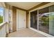 Outdoor balcony with a sliding screen door, white railings and view of the surrounding trees at 8200 E 8Th Ave # 5-204, Denver, CO 80230