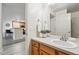 Well-lit bathroom featuring a sink with faucet, white towels, and views into the adjacent kitchen at 8200 E 8Th Ave # 5-204, Denver, CO 80230