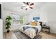 Cozy bedroom featuring a ceiling fan, large window, and ample natural light at 8200 E 8Th Ave # 5-204, Denver, CO 80230