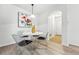 Cozy dining area with modern chairs, an artistic painting, and a view of the entryway showcasing natural light at 8200 E 8Th Ave # 5-204, Denver, CO 80230