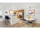 Bright kitchen featuring wood cabinets, stainless steel appliances, a breakfast bar, and a dining area with modern seating at 8200 E 8Th Ave # 5-204, Denver, CO 80230