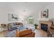 Bright living room featuring a fireplace, balcony access, and comfortable seating at 8200 E 8Th Ave # 5-204, Denver, CO 80230