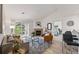 Bright living room with fireplace, balcony access, and views into the primary bedroom at 8200 E 8Th Ave # 5-204, Denver, CO 80230