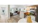 Open-concept living space with fireplace, bright kitchen, and dining area at 8200 E 8Th Ave # 5-204, Denver, CO 80230