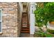 Exterior staircase leading to the upper-level units with stone facade at 8200 E 8Th Ave # 5-204, Denver, CO 80230