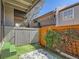 Enclosed backyard with artificial turf, wooden fencing, and outdoor privacy at 2301 E Fremont Ave # W03, Centennial, CO 80122