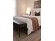 Cozy bedroom featuring a decorative rug, bench, and a comfortable bed with stylish pillows and a warm blanket at 2301 E Fremont Ave # W03, Centennial, CO 80122