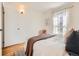 Bright bedroom with hardwood floors, neutral décor, and a large window at 2301 E Fremont Ave # W03, Centennial, CO 80122