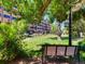 Serene community park with lush greenery and a wooden bench under a shady tree at 2301 E Fremont Ave # W03, Centennial, CO 80122