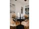 Well-lit dining area showcasing a round table, wicker chairs, and decorative vases at 2301 E Fremont Ave # W03, Centennial, CO 80122