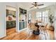 Open concept dining space featuring a rustic table, green cabinets, and hardwood floors at 2301 E Fremont Ave # W03, Centennial, CO 80122