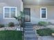 Inviting front entrance with well-maintained landscaping and a secure iron gate on a multi-Gathering home at 2301 E Fremont Ave # W03, Centennial, CO 80122