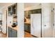 Well-lit kitchen area with olive green cabinets, butcher block counters, and stainless steel appliances at 2301 E Fremont Ave # W03, Centennial, CO 80122