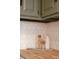 Close-up of kitchen counter featuring geometric backsplash, pasta, olive oil, and accessories at 2301 E Fremont Ave # W03, Centennial, CO 80122