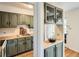 Charming kitchen with olive green cabinetry, butcher block countertops, and classic subway tile backsplash at 2301 E Fremont Ave # W03, Centennial, CO 80122