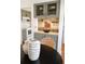 Charming kitchenette with painted cabinets, butcher block countertops, and decorative glassware at 2301 E Fremont Ave # W03, Centennial, CO 80122