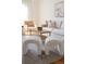 Bright living room featuring neutral tones, stylish white sofa, textured stools and modern accents at 2301 E Fremont Ave # W03, Centennial, CO 80122