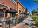Inviting restaurant patio with comfortable seating and black umbrellas at 2301 E Fremont Ave # W03, Centennial, CO 80122