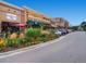 A shopping center with multiple restaurants featuring outdoor seating and landscaping at 2301 E Fremont Ave # W03, Centennial, CO 80122