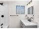 Modern bathroom with white subway tiles, gray vanity, and black fixtures at 12352 E 30Th Ave, Aurora, CO 80011