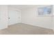 Bright bedroom with neutral walls, carpet flooring, and sliding closet doors at 12352 E 30Th Ave, Aurora, CO 80011