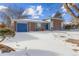 Brick home with attached garage and snowy landscape at 12352 E 30Th Ave, Aurora, CO 80011