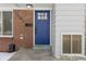 Blue front door with glass panels and brick surround at 12352 E 30Th Ave, Aurora, CO 80011