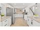 Modern kitchen featuring white cabinets and an island at 12352 E 30Th Ave, Aurora, CO 80011