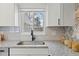 Kitchen sink with a black faucet and white subway tile backsplash at 12352 E 30Th Ave, Aurora, CO 80011