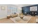 Living room with beige sofa, blue accents, and a large window at 12352 E 30Th Ave, Aurora, CO 80011