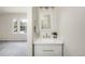 En suite bathroom featuring a contemporary vanity, decorative mirror and lots of natural light from adjacent bedroom windows at 3098 W 107Th Pl # C, Westminster, CO 80031