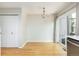 Bright dining room with hardwood floors, modern lighting, and sliding glass door at 3098 W 107Th Pl # C, Westminster, CO 80031