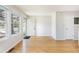 Sunny living room with hardwood floors and neutral walls. Door shown in background at 3098 W 107Th Pl # C, Westminster, CO 80031