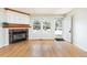 Cozy living room with hardwood floors, built-in cabinet, and inviting fireplace at 3098 W 107Th Pl # C, Westminster, CO 80031