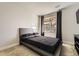 Simple bedroom with a platform bed and backyard view at 3438 Cade Ct, Castle Rock, CO 80104